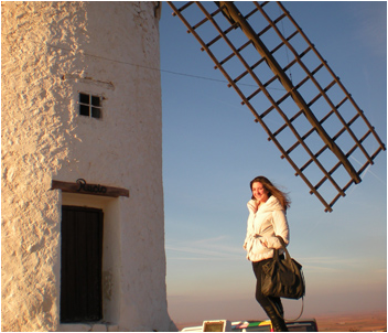 Woman standing next to windmill